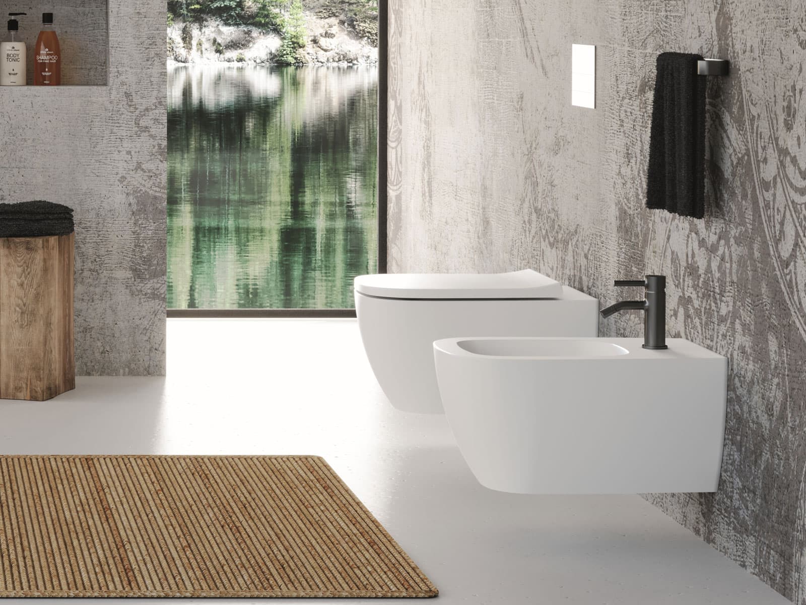 Vaso e bidet sospesi bianchi opachi con rubinetteria scura e parete materica