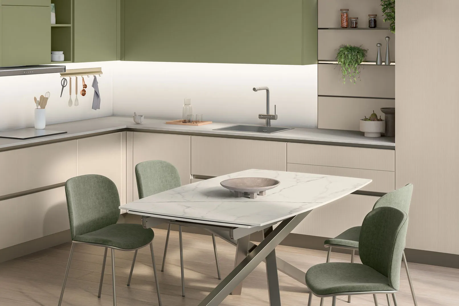 Cucina ad angolo verde salvia con tavolo in marmo