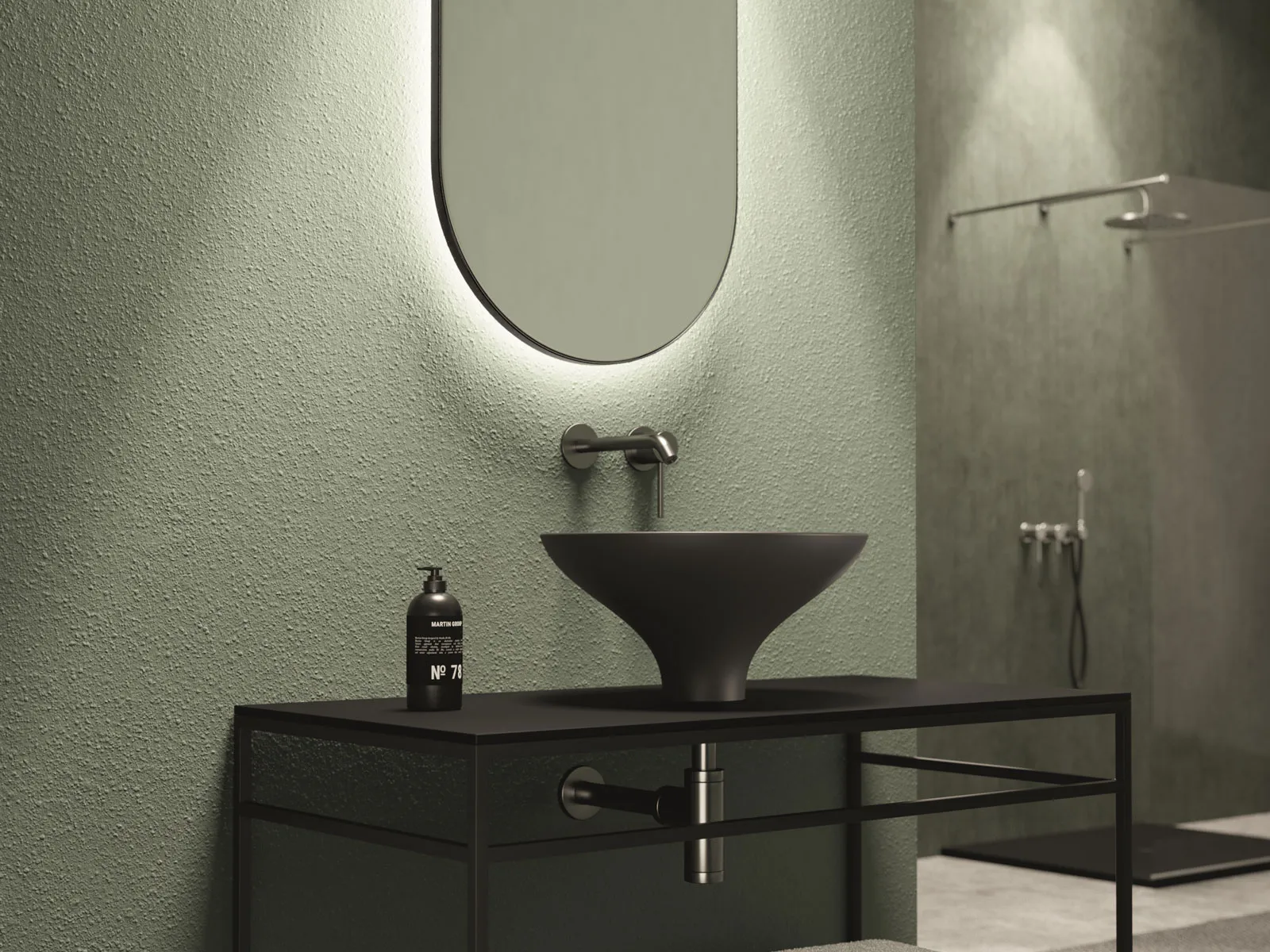 Specchio ovale retroilluminato sopra lavabo nero d'appoggio su struttura in metallo, parete verde salvia